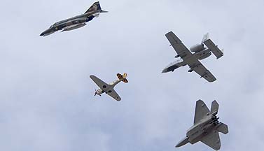 Curtiss P-40N Warhawk NL85104, McDonnell-Douglas QF-4E Phantom II 72-0140 of the 82nd Aerial Target Squadron, Lockhed-Martin F-22A Raptor 05-4098 of the 49the Fighter Wing, and Fairchild-Republic A-10A Warthog 80-0238 of the 355th Wing, Luke Air Force Base, March 19, 2011